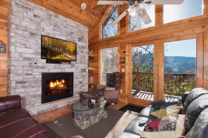 The interior of a Gatlinburg cabin with a stone fireplace.